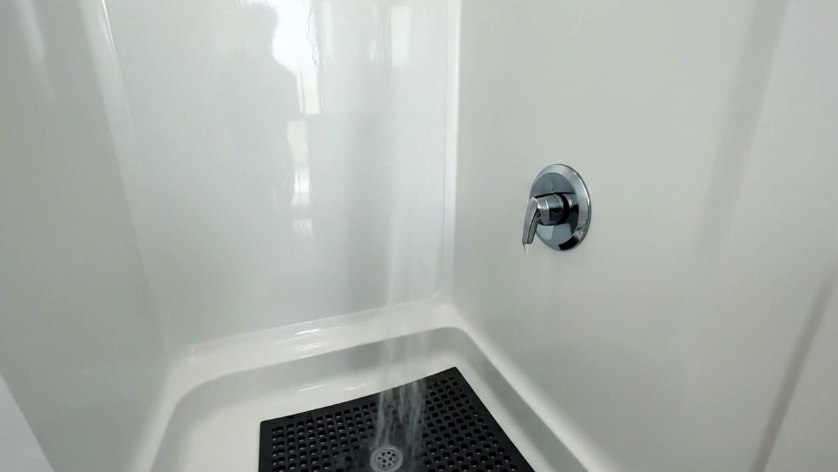 Finished interior of a Utah Shower Trailers unit with vanity, mirror and private stall