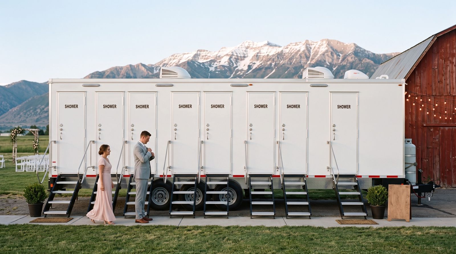Eight-door shower trailer set beside a red barn at a Heber Valley ranch wedding